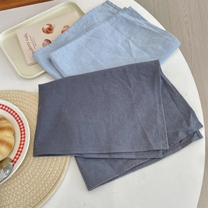 Modern heat-resistant solid color fabric placemats in grey and blue for dining table