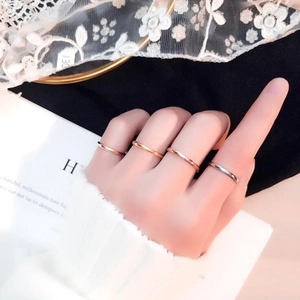Minimalist stackable thin ring set in 18K gold and silver finish on female hand