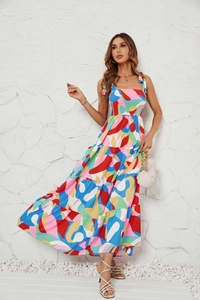 Close-up of summer dress featuring multicolor abstract print and layered hem details