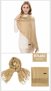 Detailed macro view of khaki cashmere scarf texture featuring soft frayed tassel edges