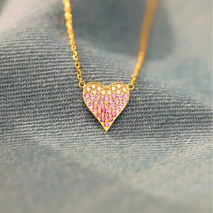 S925 silver heart necklace with pink gradient zircon pendant on blue denim fabric