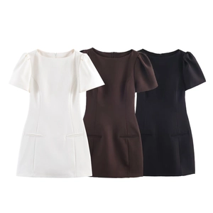 Three puff sleeve mini dresses in black, white, and brown with decorative pockets