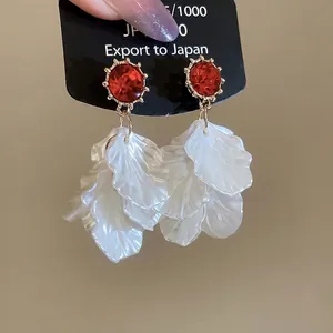 Elegant floral tassel earrings with red rhinestones and white acrylic petals on gold studs
