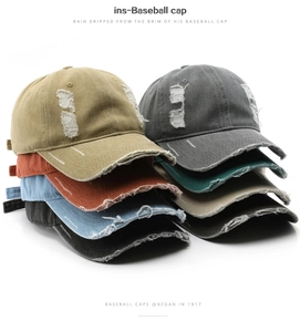 Close-up of distressed cotton baseball caps featuring washed fabric and vintage frayed details