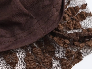 Close-up of brown long dress featuring floral lace trim and high-quality stitching details