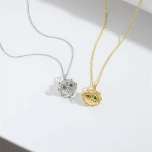 Retro owl pendant necklace set in gold and silver finish with sparkling green gemstone eyes