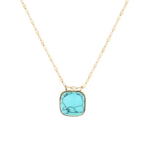 Detailed macro view of square turquoise pendant with natural black veins on gold chain