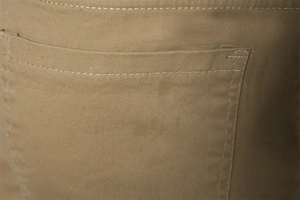 Close-up of khaki twill cotton cargo pants showing back pocket stitching and fabric