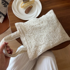 Detail of delicate lace embroidery on a vintage French style crochet tote bag