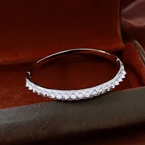 Silver-plated open cuff bracelet with pyramid rivets and white micro-set zircon accents