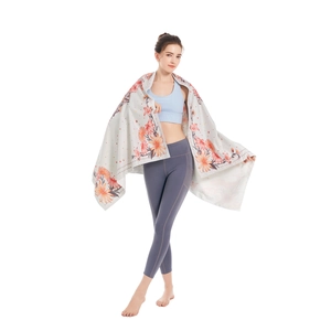 Microfiber beach towel with orange floral print and absorbent quick-dry fabric