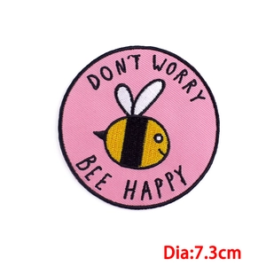 Round pink cartoon bee embroidery patch with Don't Worry Bee Happy text for clothing DIY