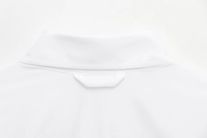 Detail of the white shirt collar showing button closure and smooth fabric texture