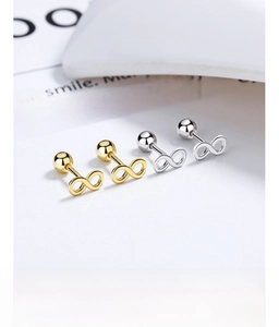 Detail view of gold and silver infinity screw back studs in 925 sterling silver