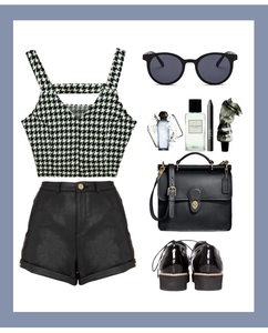 Flat lay of houndstooth crop top, leather shorts, and vintage oversized sunglasses