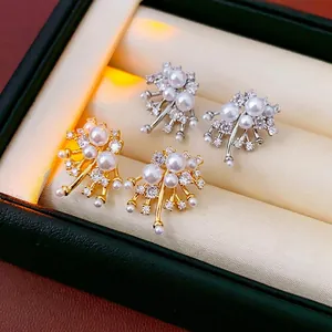 Luxurious fireworks pearl stud earrings in gold and silver finish with crystal clusters