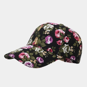 Close-up of floral pattern detail on a black canvas baseball cap with vivid rose print