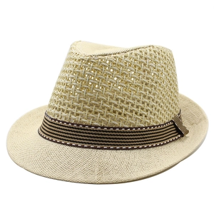 Detail of breathable hollow mesh weave on summer straw fedora with striped ribbon trim