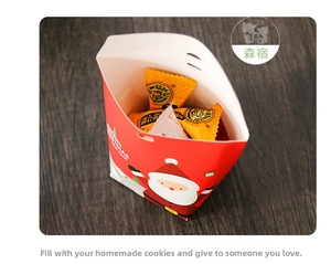 Detailed view of red Christmas gift box with Santa motif filled with festive candies