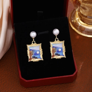 Detailed close-up of French vintage floral earrings with blue oil painting and white pearls