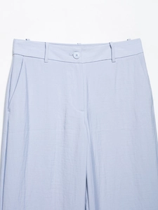 Close-up of high-waist design with single button and belt loops on these tailored trousers