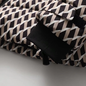 Close-up of windproof cuffs with adjustable velcro on a geometric pattern ski jacket