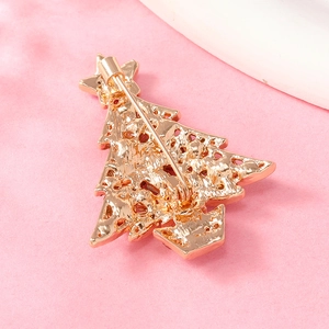 Detail of Christmas tree brooch back with secure pin clasp on textured pink background