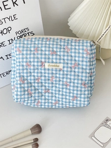 Quilted blue plaid makeup bag with pink bow patterns and zipper ribbon detail