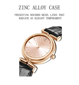 Detail of rose gold zinc alloy watch case with elegant rounded lines on black leather strap