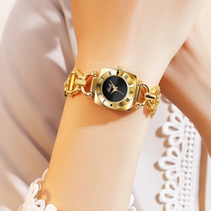 Detail of a vintage square gold watch with black dial and unique chain bracelet strap