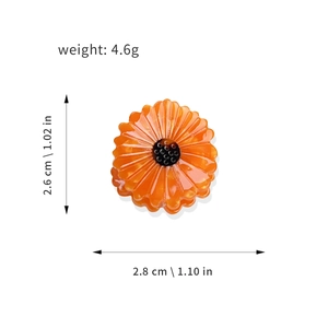 Orange sunflower acetate hair clip with black core and dimensional measurements