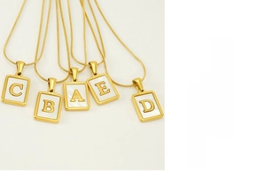Detail of 18K gold stainless steel snake chain necklace with shell letter pendant