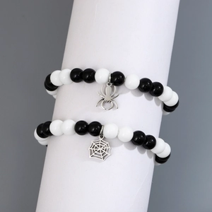 Couples black and white beaded bracelets set with spider and web silver charms