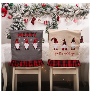 Detail of Christmas chair covers with gnome prints and red black plaid pleated edges