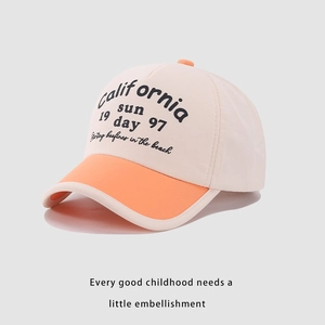 Detail of child baseball cap with California sun print in cream and orange fabric
