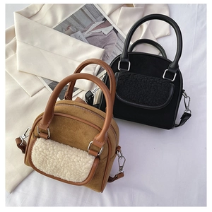 Detail of plush faux fur patchwork and matte suede texture on two crossbody saddle bags