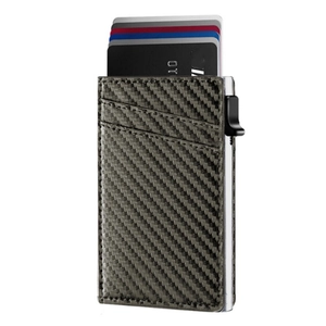 Detail of grey carbon fiber wallet showing pop-up card mechanism and textured card slots