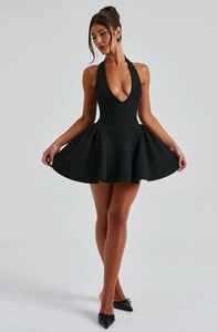 Detail of the deep V-neckline and ruffled skirt on this black halter mini dress