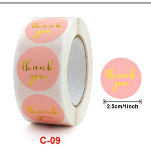 Detail of pink round thank you stickers in 1-inch roll for gift packaging
