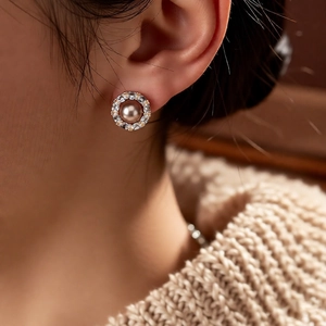 Close-up of pearl flower stud earring with champagne pearl and cubic zirconia