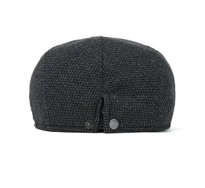 Detail of dark grey winter newsboy cap back with V-opening and metallic silver button