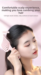 Detailed view of pink curved hairbrush with 120 elastic bristles for scalp massage