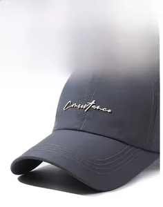 Detailed macro of the stiff grey baseball cap brim and elegant golden metal logo script