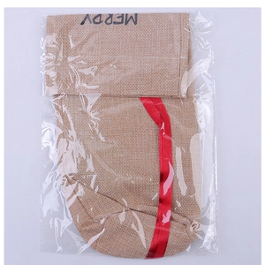 Detail of burlap Christmas wine bottle bag featuring Merry print and red satin drawstring