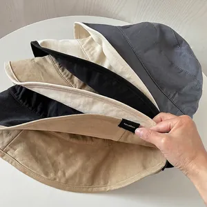 Minimalist double-sided cotton bucket hat for sun protection in four classic colors