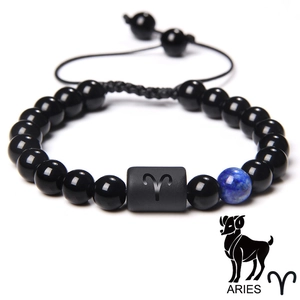 Minimalist Aries zodiac braided bead bracelet with black beads on a white background