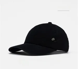 Close-up of black cotton baseball cap featuring sport embroidery and metal brand plate