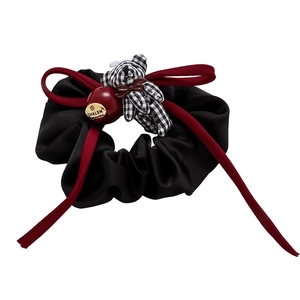 French black and white plaid bear hair tie with red bow and beads on white background