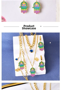 Detailed view of colorful enamel Hamsa Hand and Evil Eye pendant jewelry set