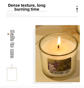 Close-up of a lit scented candle in a glass jar with lavender and juniper fragrance